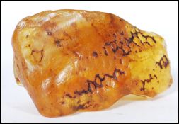 A piece of raw uncut copal amber. Measures approx 7cm wide by 3cm high.