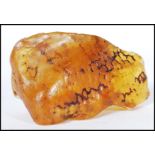 A piece of raw uncut copal amber. Measures approx 7cm wide by 3cm high.