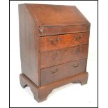 An 18th century country oak ladies writing bureau on stand. Of small proportions, the bureau with