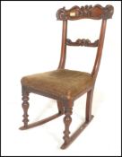 An 18th Century Georgian Regency mahogany bar back rocking chair, carved backrest raised on turned