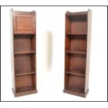 A pair of Edwardian solid mahogany upright pedestal bookcases. Each with plinth bases having open