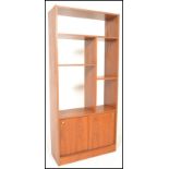 A retro 20th Century teak wood room divider having a configuration of shelves and cupboards.