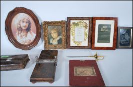 A collection of items to include picture frames, one from Harrods, tie press, early 20th Century