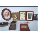 A collection of items to include picture frames, one from Harrods, tie press, early 20th Century