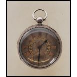 A Gent`s antique silver pocket watch by `L.B. Tuchman`, Birmingham, key wind, ornate silver coloured