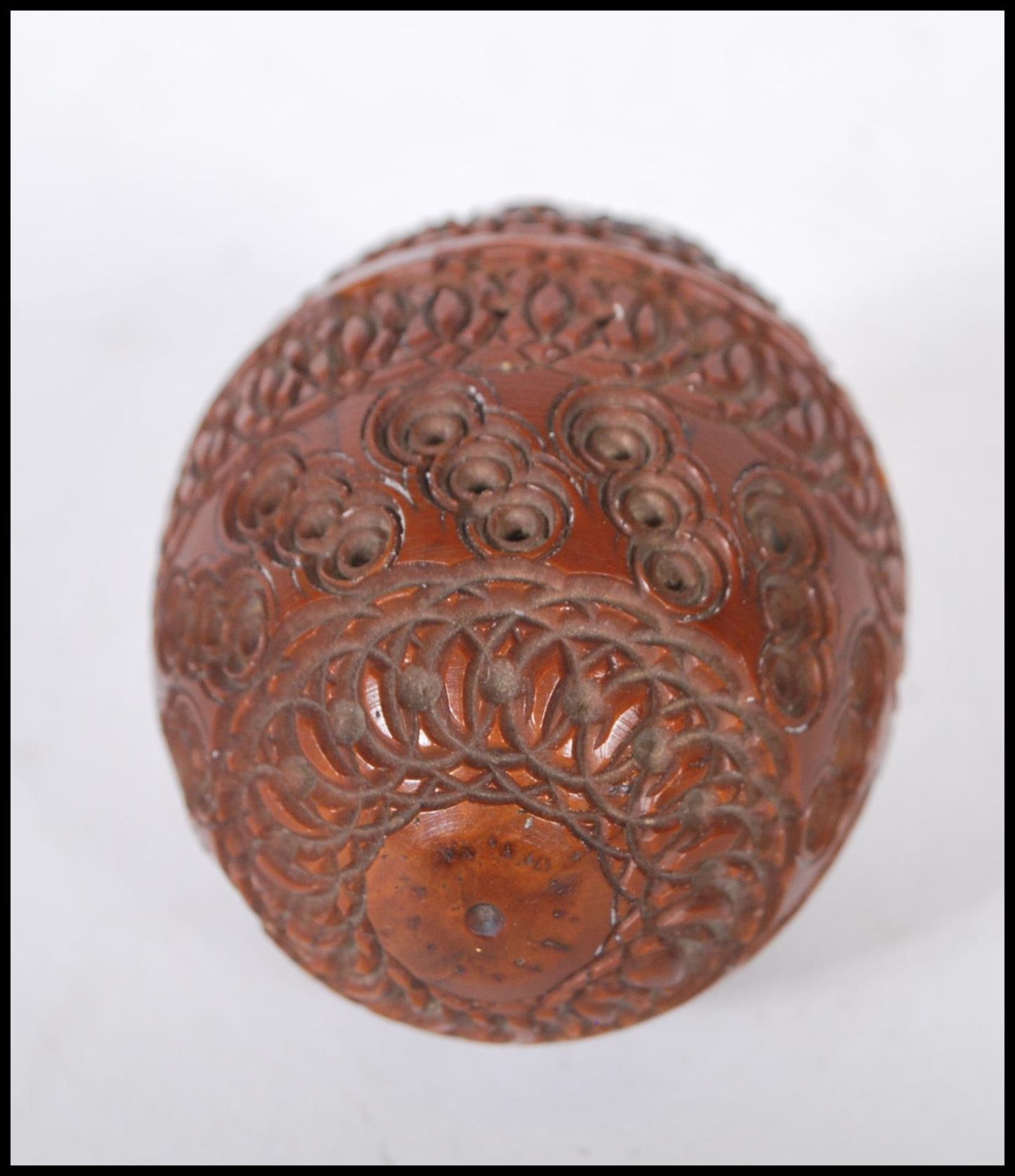 A 20th Century carved coquilla nut pomander case being carved with concentric circle patterning with - Image 2 of 4