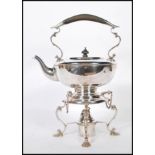 A 20th Century silver plated spirit kettle having a scrolled design handle to the top being raised