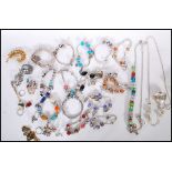 A collection of vintage and contemporary costume jewellery to include various silver charm