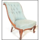 A 19th Century Victorian button backed mahogany nursing chair having carved shaped cabriole legs,