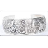 A 20th Century Chinese silver bangle bracelet having decorative repousse panels depicting birds