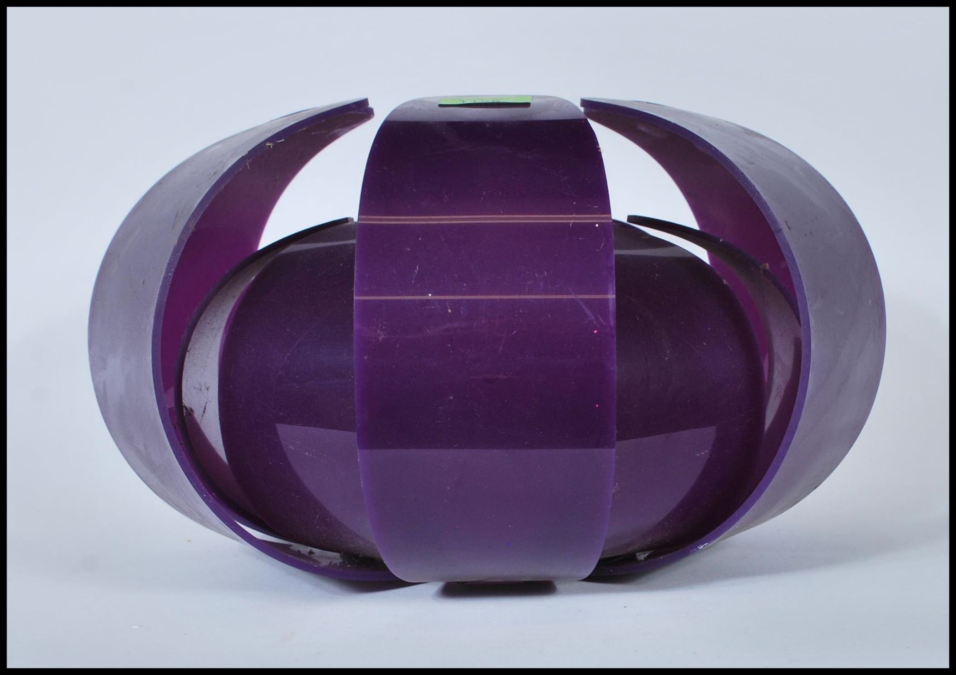 A vintage retro layered shaped ceiling light fixture, constructed from a purple moulded fabric.