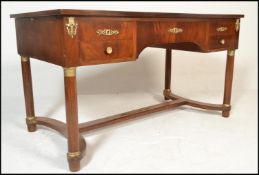 A 20th century Biedermeier walnut writing table desk. Raised on turned columns uniting by stretchers
