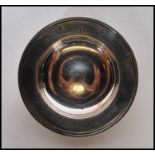 A silver hallmarked pin dish, engraved to the centre with the initials SMH, inscription to the