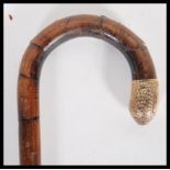 A 20th Century walking stick cane having crook han