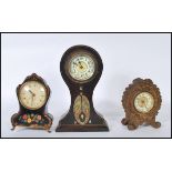 A group of three balloon shaped clocks to include