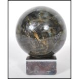 A labradorite specimen precious stone sphere on a chromed metal base. Measures approx 9cm diameter.