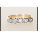 An 18ct gold and diamond five stone ring. The ring having five graduated diamonds within star
