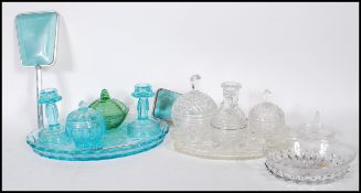 A pair of early 20th Century 1930's Art Deco blue glass dressing table sets consisting of three