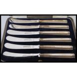 A cased set of silver hallmarked Harrods of London fruit / butter knives complete in the