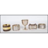A collection of four silver hallmarked non matching napkin rings together with a silver hallmarked
