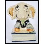 A vintage 1920's / 30's ceramic pastille burner in the form of a sheep sitting on a book having a
