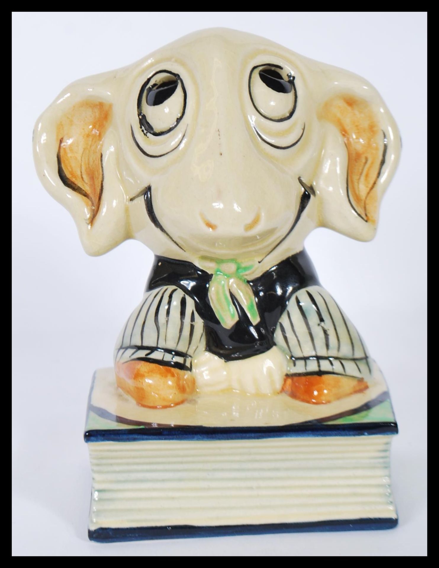 A vintage 1920's / 30's ceramic pastille burner in the form of a sheep sitting on a book having a