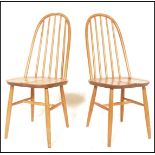 A pair of 20th Century Ercol Windsor style Priory Quaker hoop-back dining chairs in light elm,
