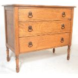 A 1920's oak bedroom chest of drawers. Raised on turned legs with a configuration of short and