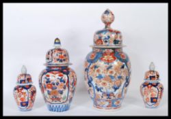 Two 19th / 18th Century Japanese Imari lidded jars of ovoid form each painted in typical style
