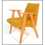 A Danish style retro 20th Century open framed beech wood lounge / fireside armchair, upholstered