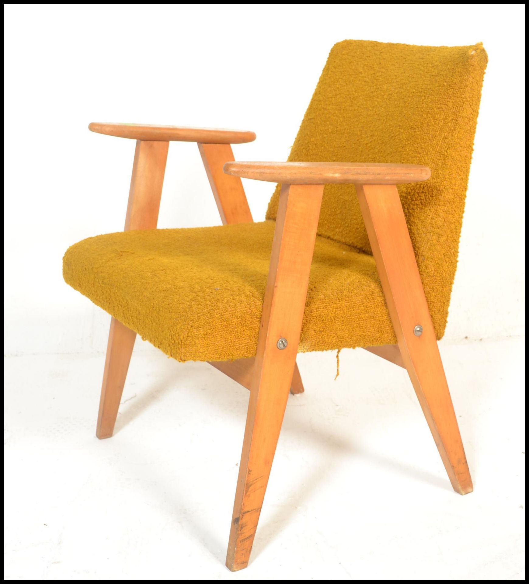 A Danish style retro 20th Century open framed beech wood lounge / fireside armchair, upholstered