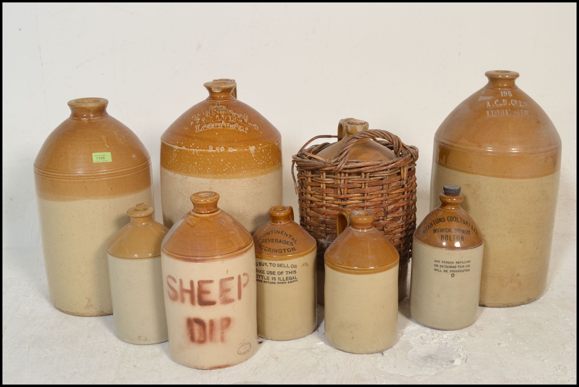 A good collection of stoneware advertising pots and flagons to include several large flagons with