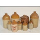 A good collection of stoneware advertising pots and flagons to include several large flagons with
