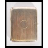 A silver hallmarked cigarette case with engine turned decoration having central monogram.