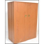 A 1970’s retro cube desk cabinet. Faux teak wood veneers with brass campaign  handles opening to