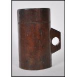 An unusual wooden tankard mug of cylindrical form having pierced small loop handle.The body with
