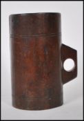 An unusual wooden tankard mug of cylindrical form having pierced small loop handle.The body with