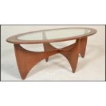 A mid century Victor Wilkins for G-Plan Oval Astro glass top teak coffee table. Lozenge form with