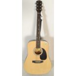A 20th Century acoustic Squire by Fender six string guitar having a shaped hollow body with mother