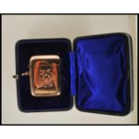 A stamped 375 9ct gold vesta case of square form having central engraved monogram with match striker