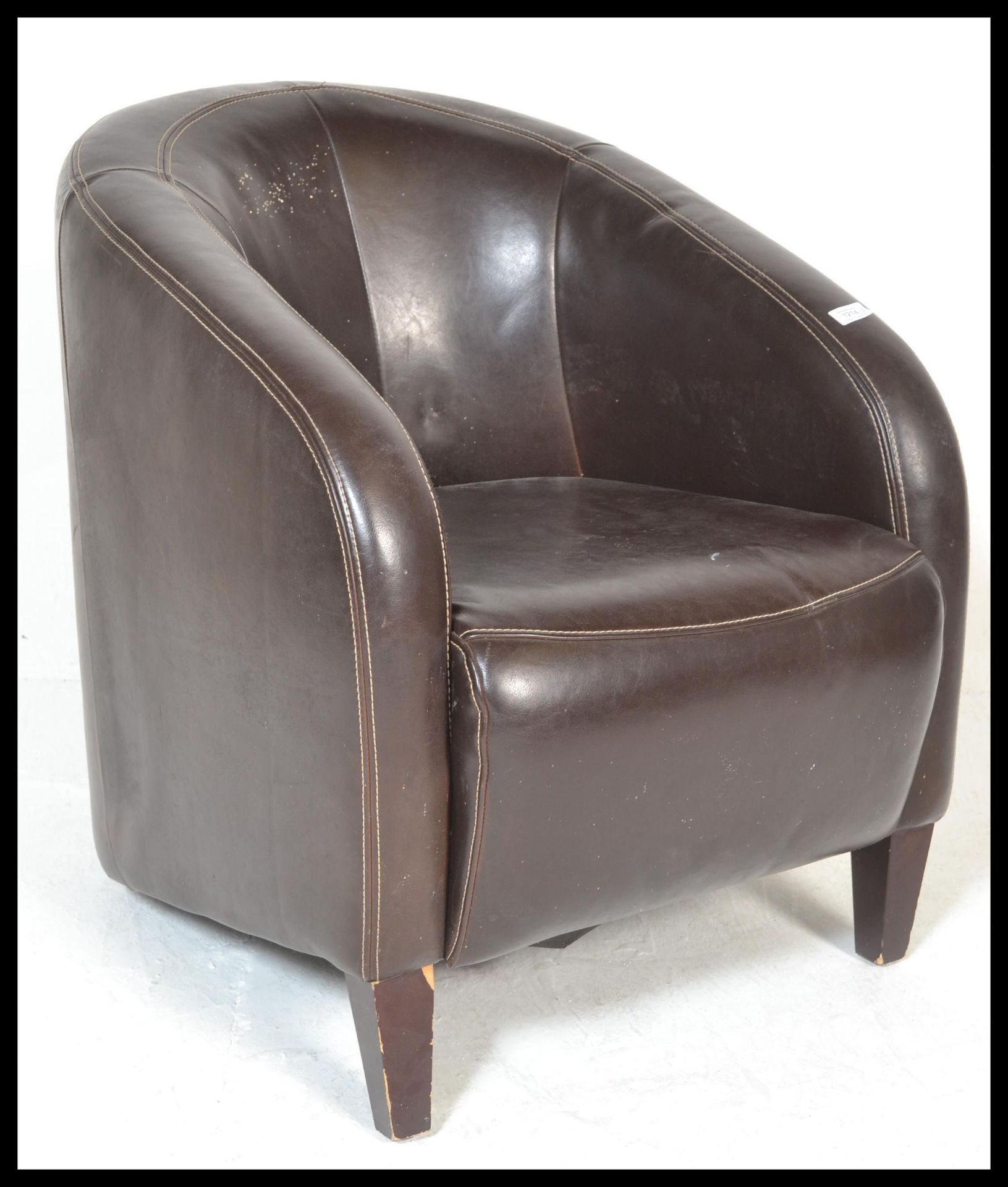 A contemporary leather tub chair / armchair. Raise