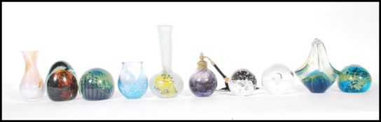 A collection of 20th Century glass wares to include paper weights and vases to include three Mdina