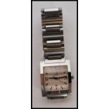 A gentleman's Dunhill facet watch having a square face with arabic numerals and baton markers to the