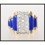 A stamped 18ct gold and diamond ring having blue lapis lazuli stepped shoulders with a pave set