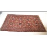 A 19th century Persian / Islamic Bokhara rug with red ground having geometric decoration to the