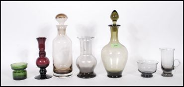 A collection of 20th Century glasswares to include an amethyst glass spill vase of knopped form, a