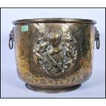 A late 19th Century high Victorian brass twin lion mask coal scuttle / log basket, armorial crest in
