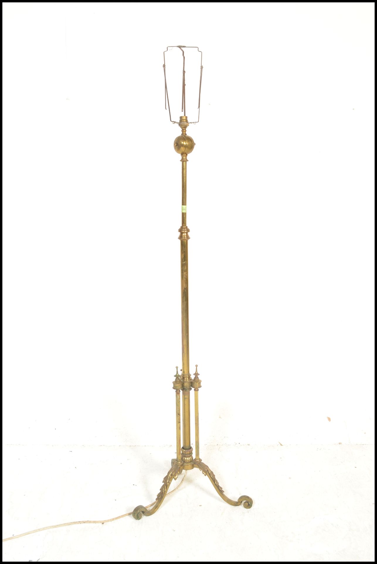 An early 20th Century Edwardian brass adjustable telescopic standard lamp being raised on three