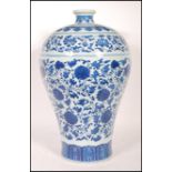 A large Chinese Kangxi blue and white baluster vase decorated with scenes of peony flowers with