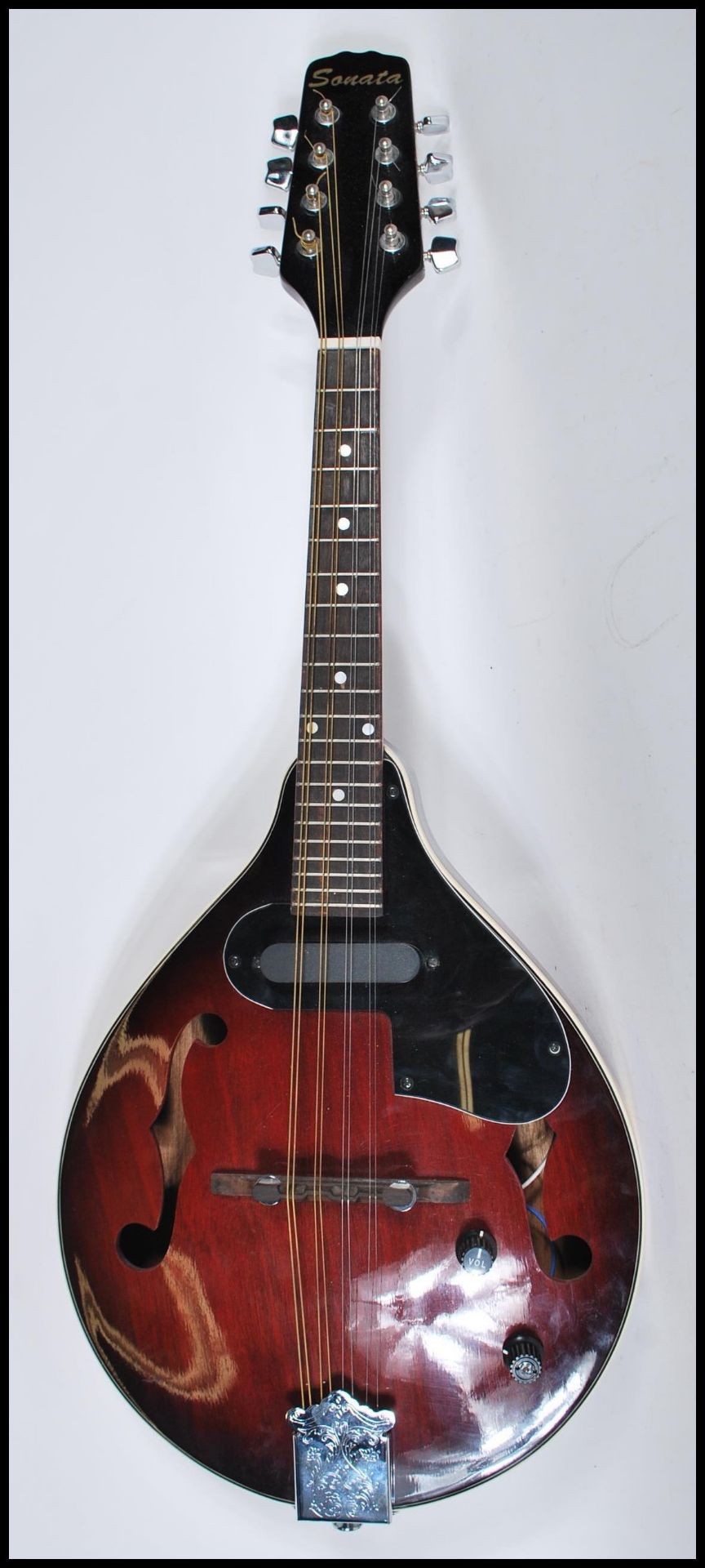 An electric eight string mandolin by Sonata having a shaped dark red body and white borders, with